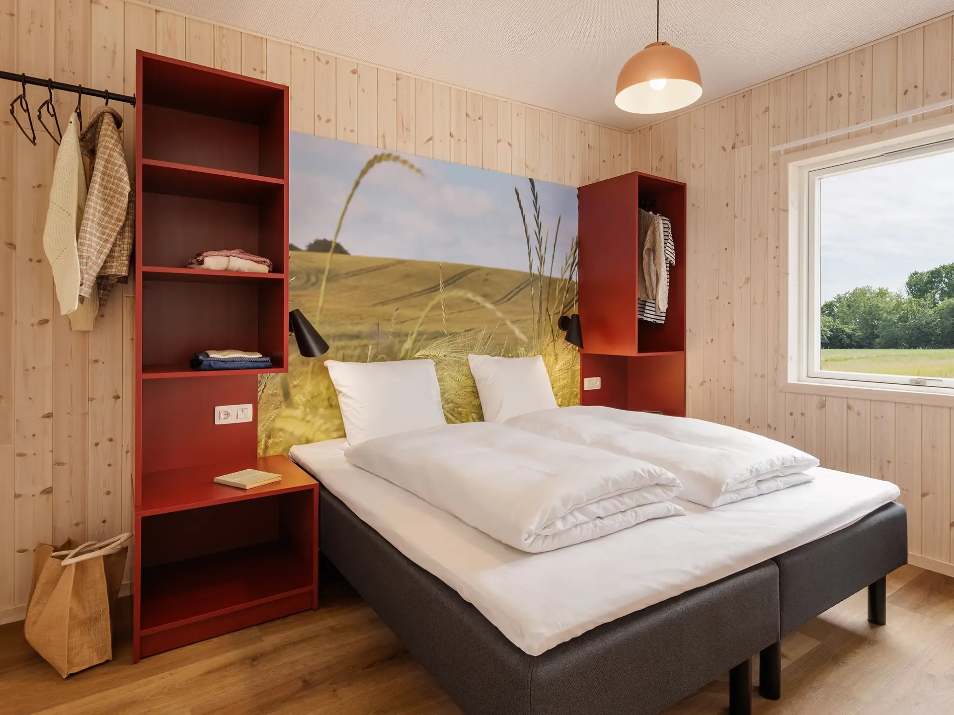Bedroom with custom-built FF&E, integrated storage and graphic wall feature in a resort cottage at Nordborg Resort.