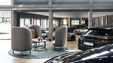 Spacious car showroom lounge featuring large Bolia lounge chairs and soft seating for premium hospitality.