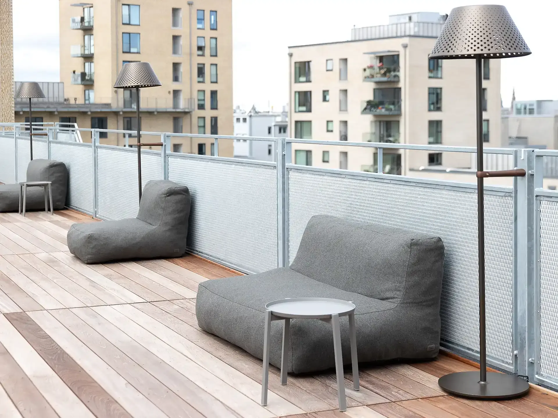 Hotel rooftop terrace design with seating area and panoramic city views.