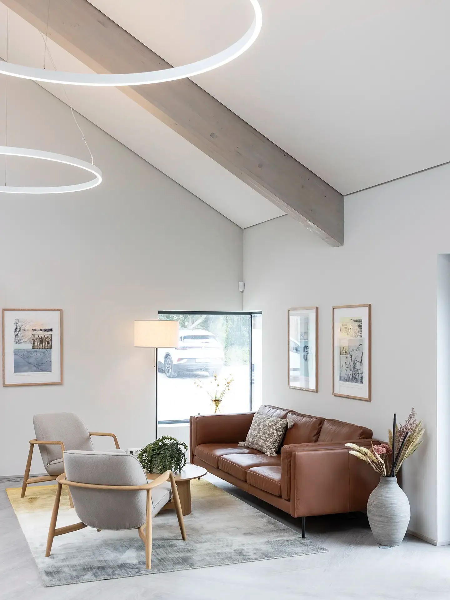 Modern hotel lounge with leather sofa and large windows for natural light.