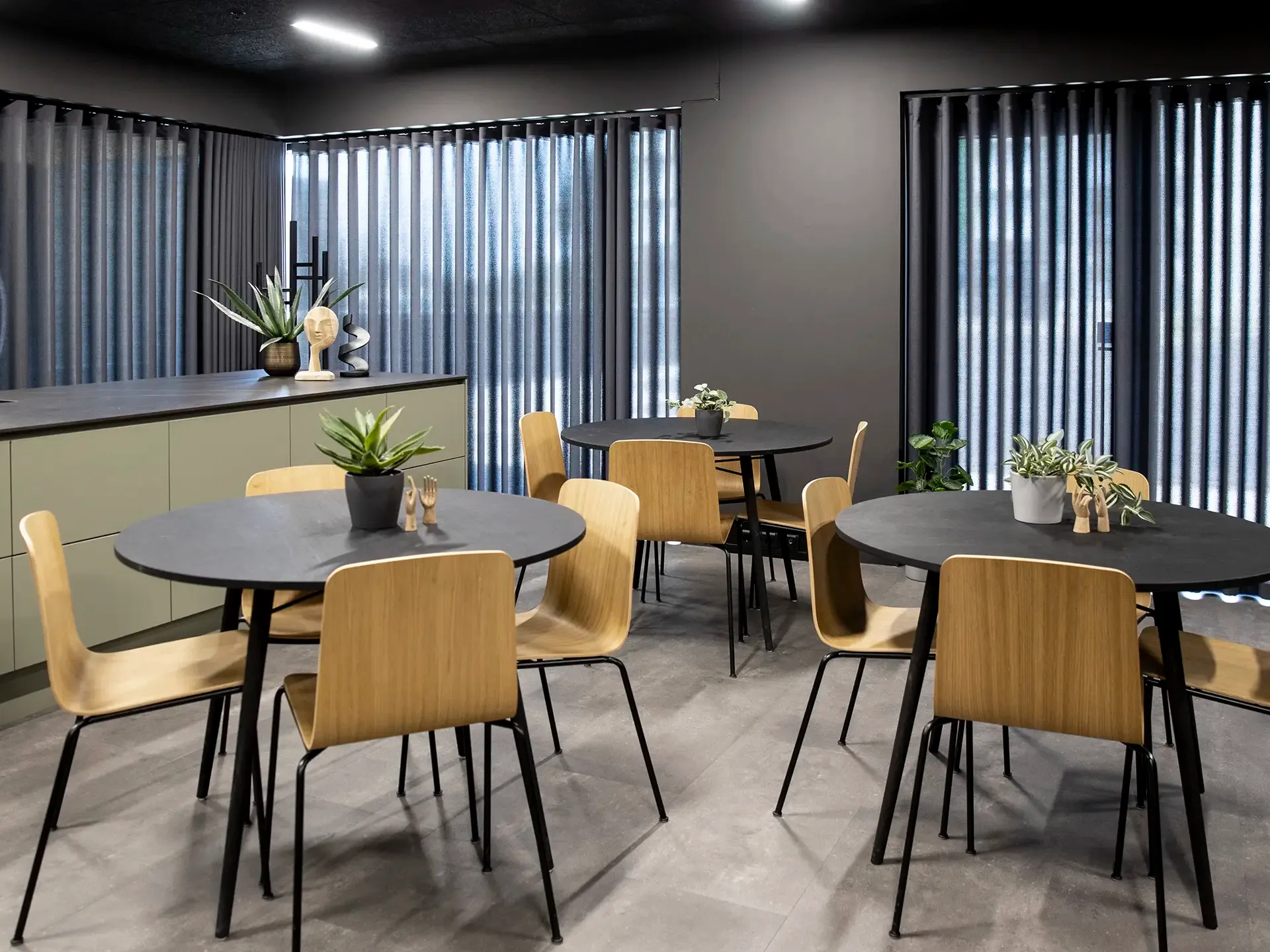 Flexible dining furniture with chairs and round tables, supporting club café operations and informal meeting zones.