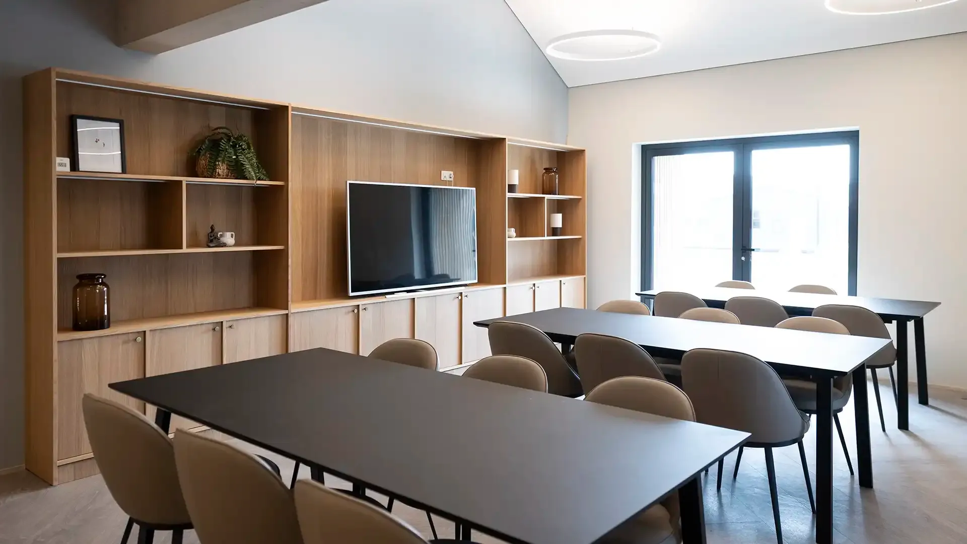Meeting room design with contemporary furniture for hotels. Custome-made bookcase with audio-visual equipment.