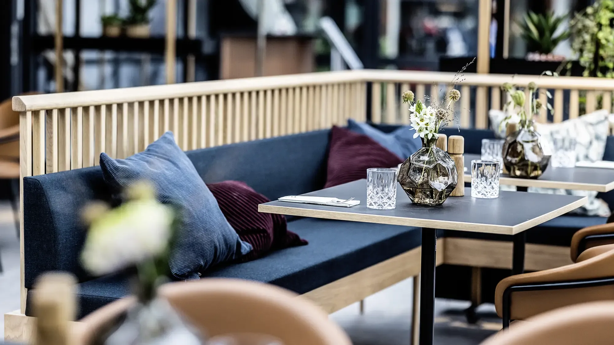 Custom made bench seat in wood with cushion at restaurant HimmerLand. 