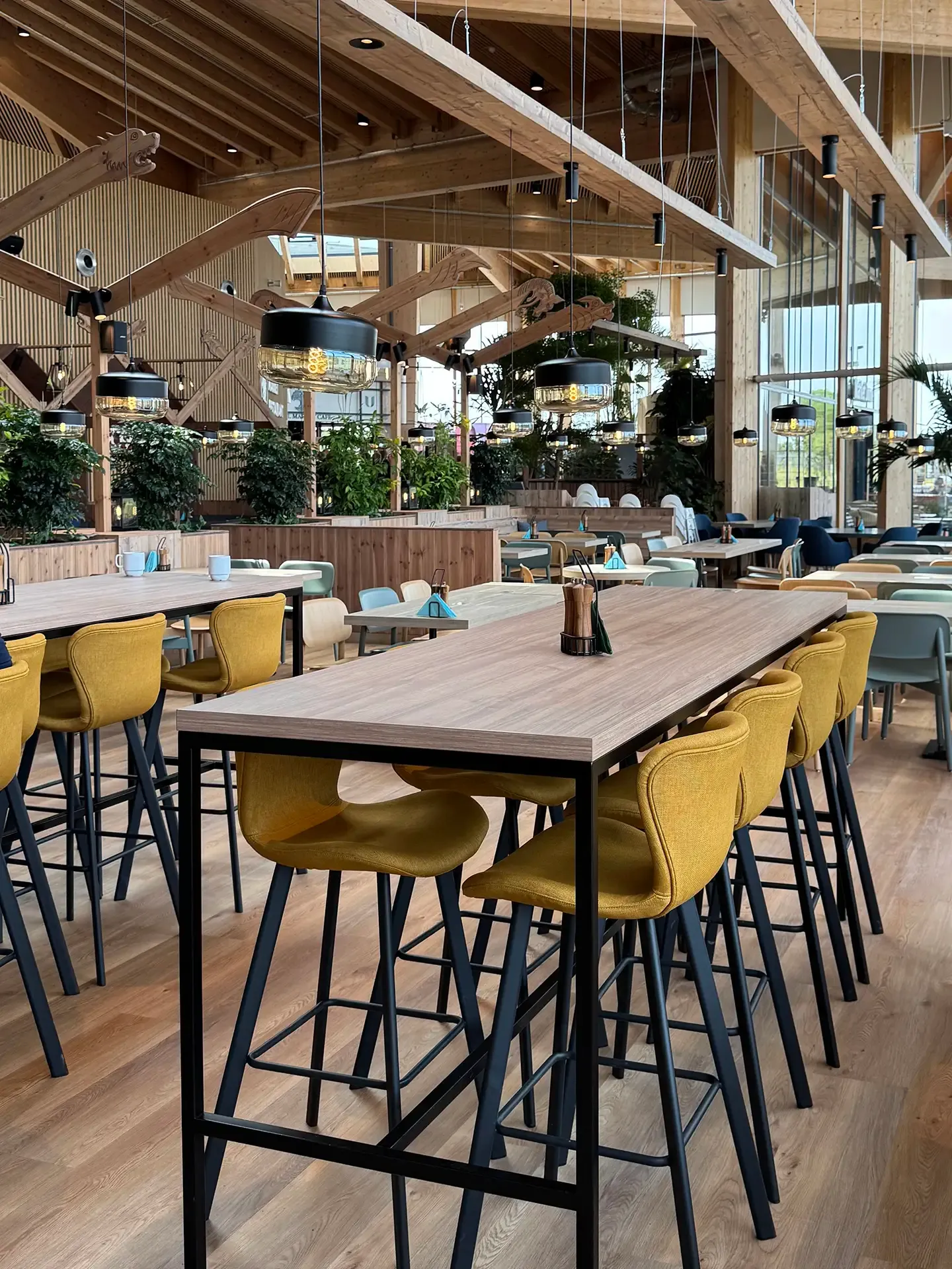 Large-scale dining area featuring FF&E specification, communal tables, and durable seating at Nordborg Resort.