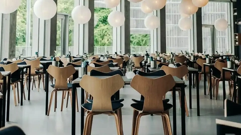 Spacious dining area at Tivoli Friheden featuring Grand Prix chairs by Fritz Hansen – ideal for versatile and stylish hospitality layouts.